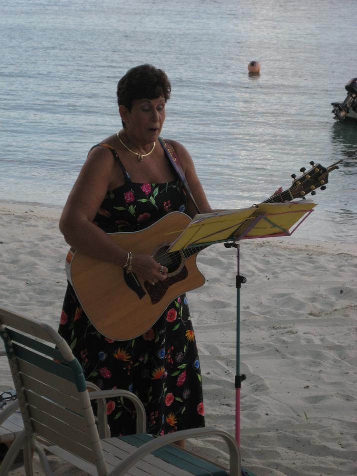 Diane singing at beach wedding